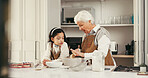 Baking, talking and child with grandmother in kitchen for teaching, bonding or development. Happy, learning and girl kid with senior woman for preparing dessert, cake or cookies together in home.