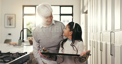 Buy stock photo Baking, happy and grandmother with girl with tray for cookies, biscuits and treats in kitchen. Family, dessert and senior woman with child in home for bonding, support and learning recipe together