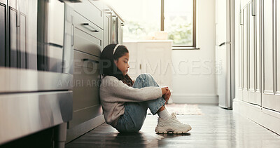 Buy stock photo Sad girl, child and thinking in home with stress, trauma and abuse victim on kitchen floor. House, depression and unhappy kid with reflection for loneliness, anxiety and mental health challenge