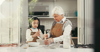 Buy stock photo Baking, mixing and child with grandmother in kitchen for teaching, bonding or development. Happy, learning and girl kid with senior woman for preparing dessert, cake or cookies together in home.