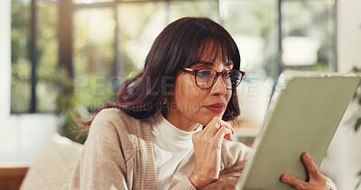Buy stock photo Woman, tablet and relax on sofa with reading ebook, glasses and literature subscription in home. Person, tech and application on couch for novel, story or search article in living room at house