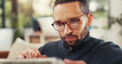 Buy stock photo Reading, research and tablet with man in living room of home for social media review of accommodation. App, online booking and travel with person in apartment for holiday or vacation planning