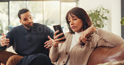Buy stock photo Woman, phone and ignore man on couch with social media addiction, talk and gesture for attention. Person, couple and smartphone with distraction, game or web chat with mobile app in lounge at house
