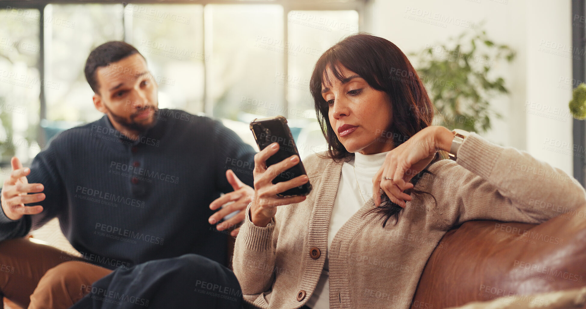 Buy stock photo Woman, phone and ignore man on couch with social media addiction, talk and gesture for attention. Person, couple and smartphone with distraction, game or web chat with mobile app in lounge at house