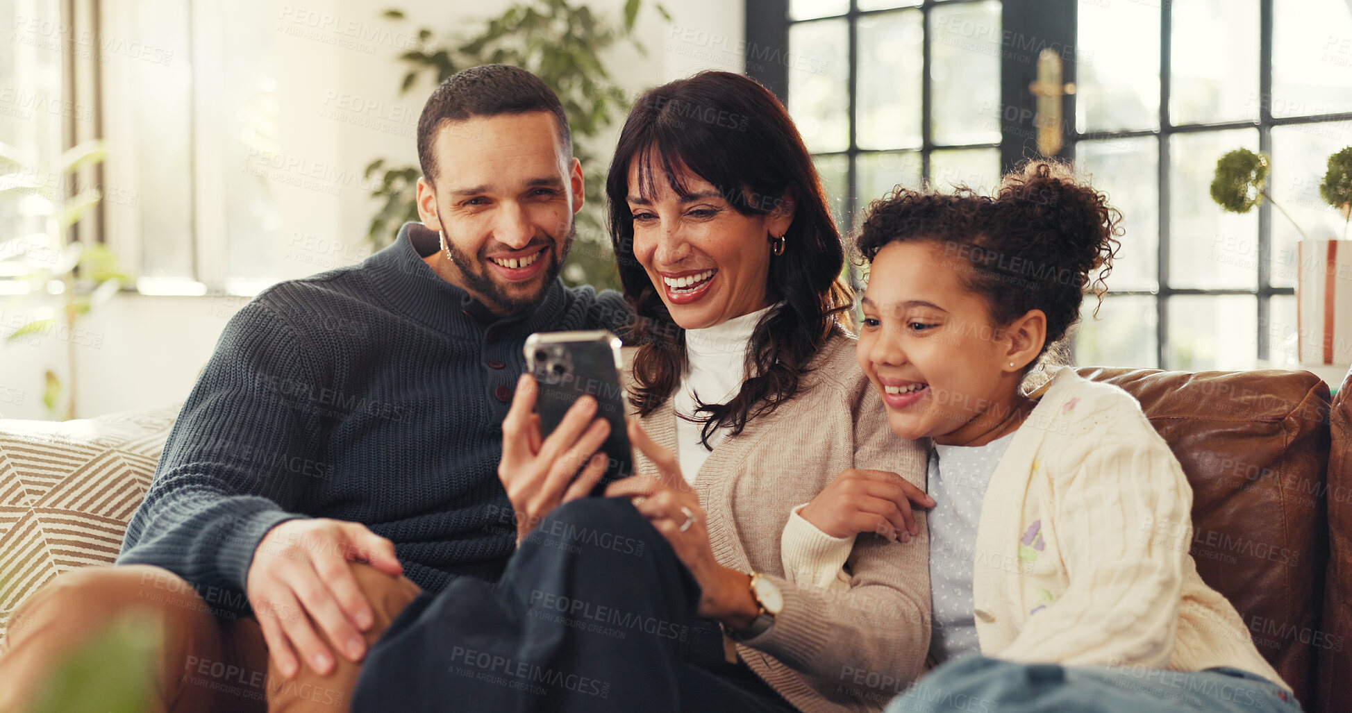 Buy stock photo Parents, girl and relax with phone on sofa, laugh and streaming funny video with bonding in lounge. Father, mother and daughter with love, smartphone and app with comic post on couch at family house
