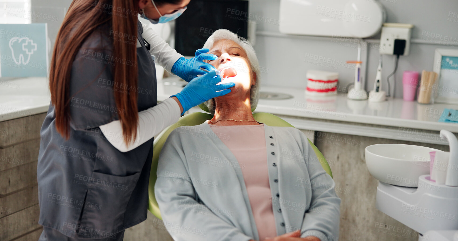 Buy stock photo Woman, dentist and torch for mouth exam, check and services for oral care in consultation room. Mature patient, doctor and light for inspection, cavity and dental hygiene for teeth at clinic