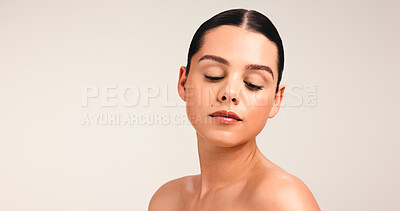 Buy stock photo Eyes closed, woman and beauty in studio space for self care, wellness and glow on white background. Mockup, serious with clean girl makeup or dermatology for healthy skin, cosmetics or natural look
