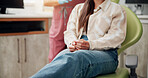 Woman, patient and hands with nerves for dental surgery, tooth extraction or pain relief at clinic. Closeup, female person or customer waiting in anticipation, stress or anxiety for dentist on chair