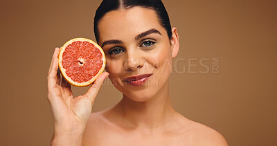 Buy stock photo Happy, woman and grapefruit with portrait for skincare, natural beauty and facial glow. Smile, person and fruit for collagen, vitamin c and organic ingredients of treatment shine in studio background