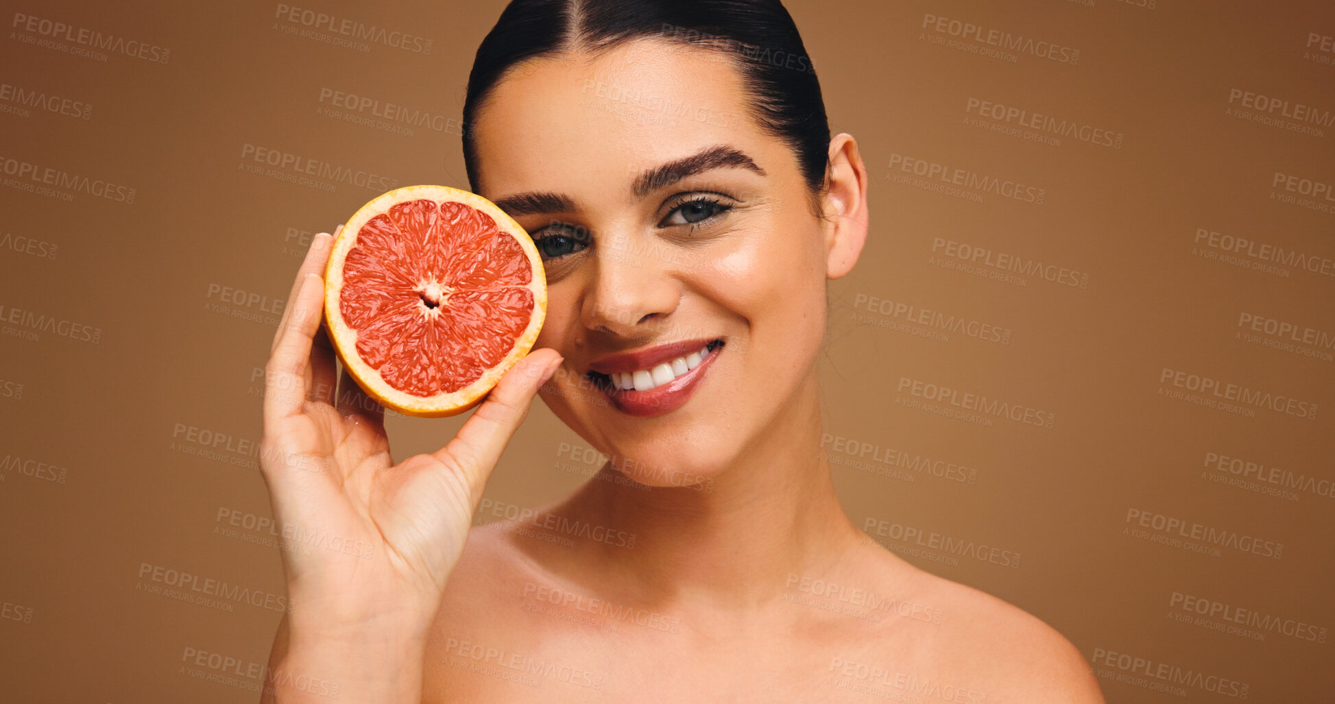 Buy stock photo Portrait, woman and grapefruit with smile for beauty, natural skincare and facial glow. Happy, person and fruit for collagen, vitamin c and organic ingredients of treatment shine in studio background