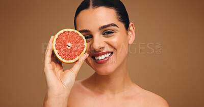 Buy stock photo Portrait, woman and proud with grapefruit for skincare, natural beauty and facial glow. Happy, person and fruit for collagen, vitamin c and organic ingredients of treatment shine in studio background