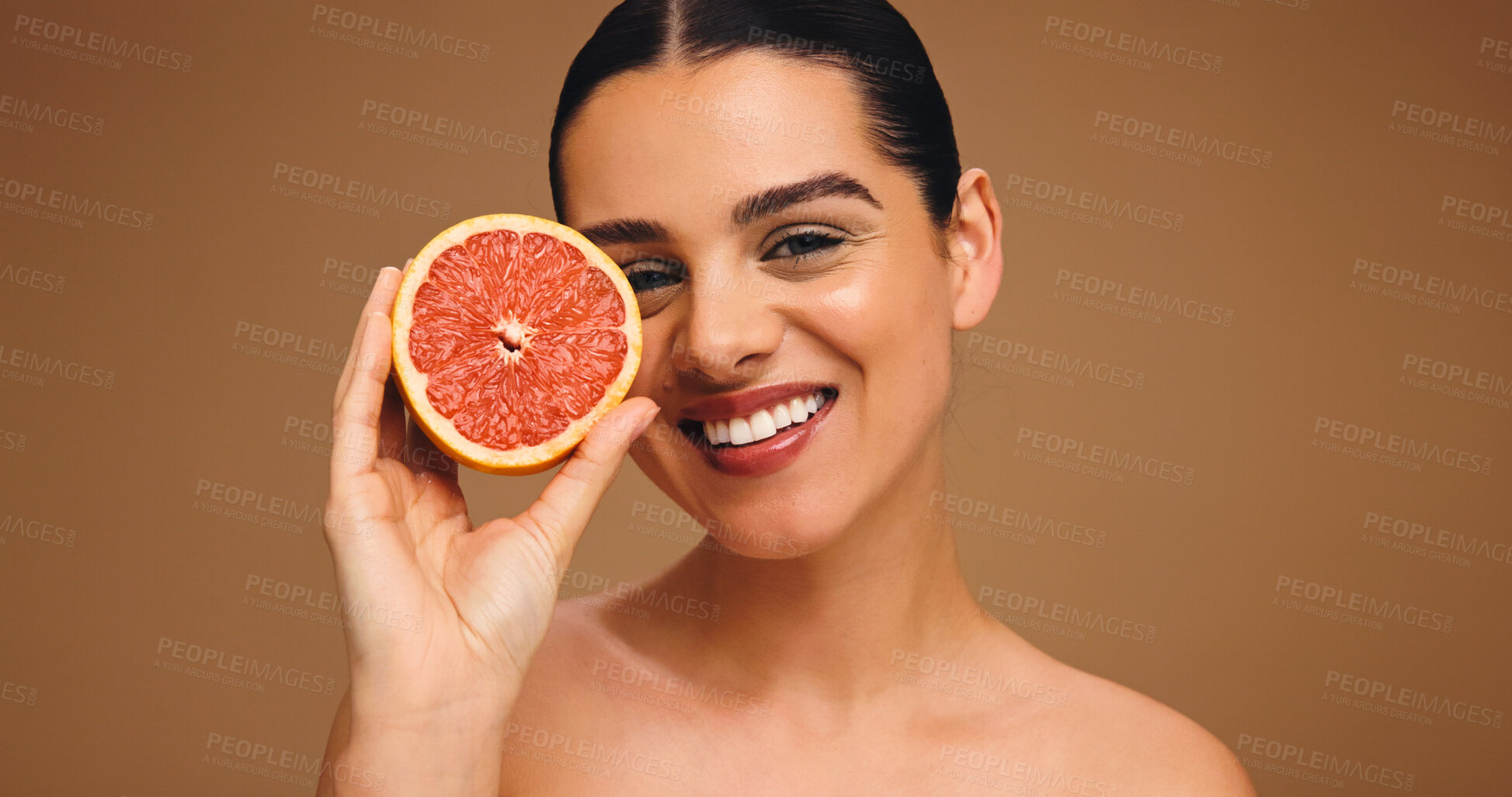 Buy stock photo Portrait, woman and proud with grapefruit for skincare, natural beauty and facial glow. Happy, person and fruit for collagen, vitamin c and organic ingredients of treatment shine in studio background