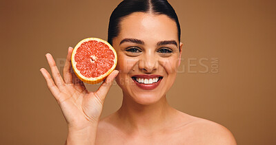 Buy stock photo Happy woman, portrait or skincare with grapefruit for glowing skin on a studio background. Face, female person or model with smile or natural organic fruit for vitamin C or antioxidant on space
