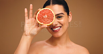 Buy stock photo Happy woman, portrait or beauty with grapefruit for natural skincare or self care on a studio background. Healthy skin, female person or model with smile or organic fruit for vitamin C space