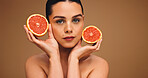 Woman, portrait or beauty with grapefruit for diet or nutrition on a studio background. Face, female person or model with natural organic fruit for vitamin C, skincare or health detox on mockup space
