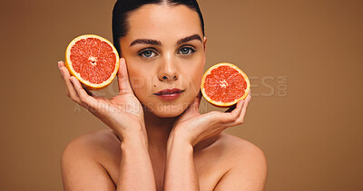Buy stock photo Woman, portrait or beauty with grapefruit for diet or nutrition on a studio background. Face, female person or model with natural organic fruit for vitamin C, skincare or health detox on mockup space