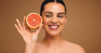 Buy stock photo Happy woman, beauty and skincare with grapefruit for diet or nutrition on a studio background. Face, female person or model with smile for natural organic fruit, vitamin C or health detox on space