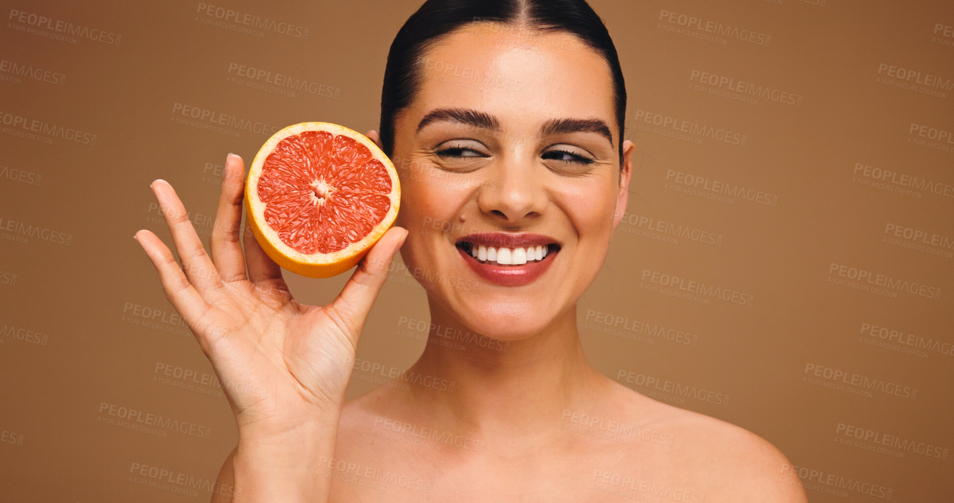Buy stock photo Happy woman, beauty and skincare with grapefruit for diet or nutrition on a studio background. Face, female person or model with smile for natural organic fruit, vitamin C or health detox on space
