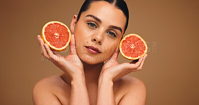 Buy stock photo Woman, portrait or beauty with grapefruit for hydration or glowing skin on a studio background. Face, female person or model with natural organic fruit for skincare, vitamin C or antioxidant on space