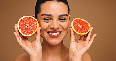 Buy stock photo Portrait, woman and grapefruit for shine of skincare, natural beauty and facial glow. Happy, person or citrus fruit for collagen, vitamin c and organic ingredients of dermatology in studio background