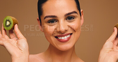 Buy stock photo Skincare, kiwi and portrait of woman in studio for vitamin c, beauty and antioxidants glow. Self care, organic dermatology and natural enzyme facial with person and fruit on brown background