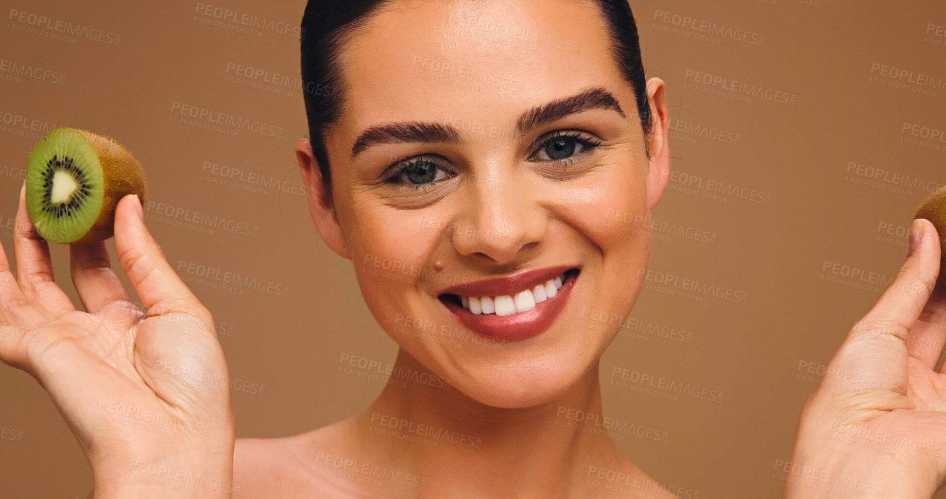 Buy stock photo Skincare, kiwi and portrait of woman in studio for vitamin c, beauty and antioxidants glow. Self care, organic dermatology and natural enzyme facial with person and fruit on brown background