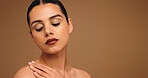 Woman, touch shoulder and skincare in studio, mockup space and glow with results on background. Person, model and eyes closed for wellness, beauty and cosmetics with makeup, change and dermatology