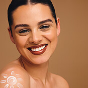 Colorful Sunscreen Protrait Portrait, sunscreen and woman in studio, smile and dermatology on brown ...