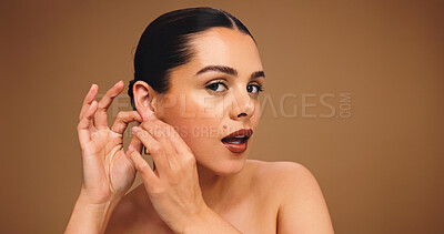 Buy stock photo Girl, beauty and earring with studio portrait, pride and confidence with mockup space on background. Woman, model and face with cosmetics for glow, makeup and jewellery with transformation in Australia