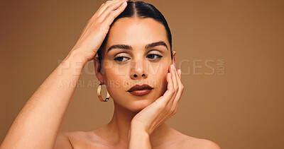 Buy stock photo Beauty, hands and face of woman in studio for cosmetics, transformation and makeup. Mockup space, salon and person with confidence, facial glow and spa aesthetic for skincare on brown background
