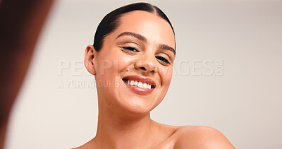 Buy stock photo Portrait, woman and selfie in studio, skincare and post for beauty tips on social media and picture. White background, influencer and person with smile for healthy skin, wellness and photography