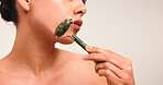 Skincare, hands and woman with facial roller in studio with natural, cosmetic and glow. Health, mockup space and female person with face tool for dermatology routine for wellness by white background