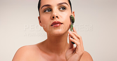 Buy stock photo Woman, jade roller and skincare with beauty in studio, mockup space and thinking on white background. Girl, dermatology and stone tools for circulation, reflection and perspective with facial massage