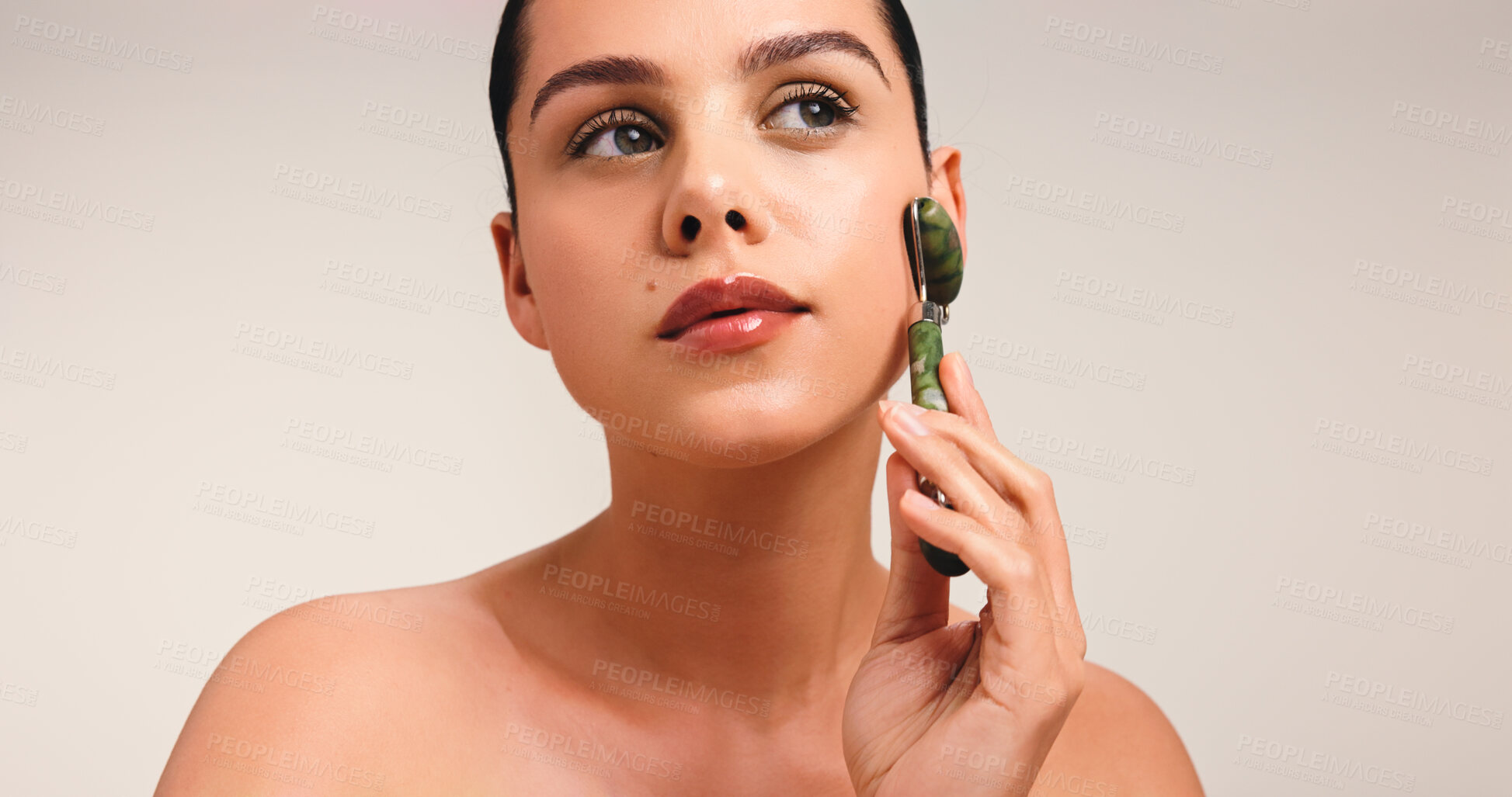 Buy stock photo Woman, jade roller and skincare with beauty in studio, mockup space and thinking on white background. Girl, dermatology and stone tools for circulation, reflection and perspective with facial massage