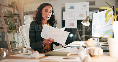 Buy stock photo Computer, documents and finance with business woman in office at night for review of information. Data, paperwork and reading with corporate employee in financial workplace for evening administration