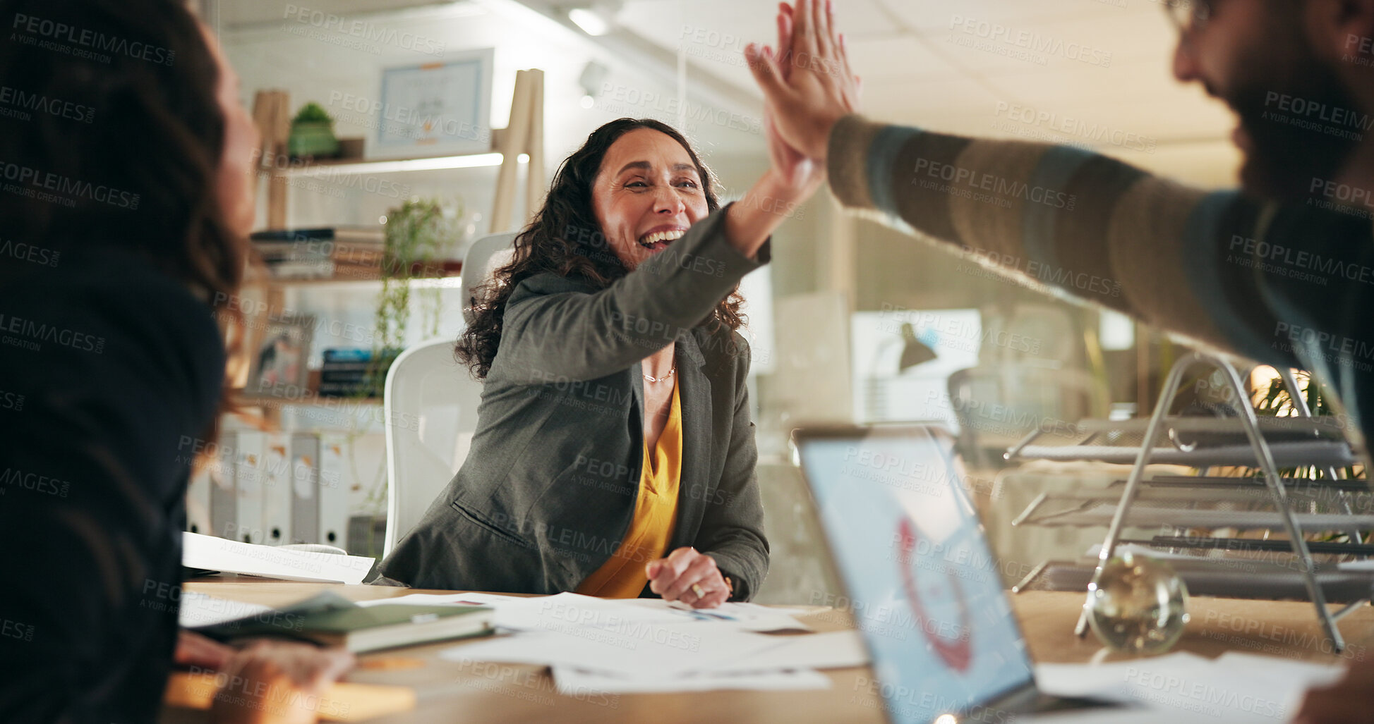 Buy stock photo Business people, celebration and high five for professional win, media campaign success and stats. Happy, hand gesture and employees with achievement for creative collaboration, laptop and PR data