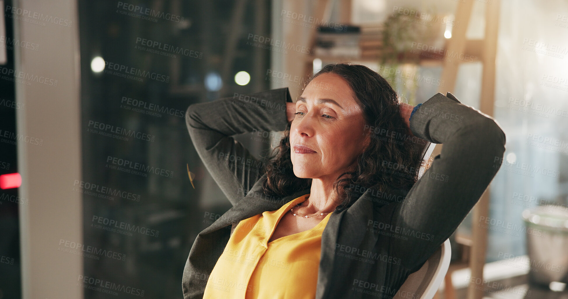 Buy stock photo Break, complete and night with business woman in office to relax or rest after hours, deadline or tasks. Corporate, finish and hands behind head with mature employee at work for dedication in evening
