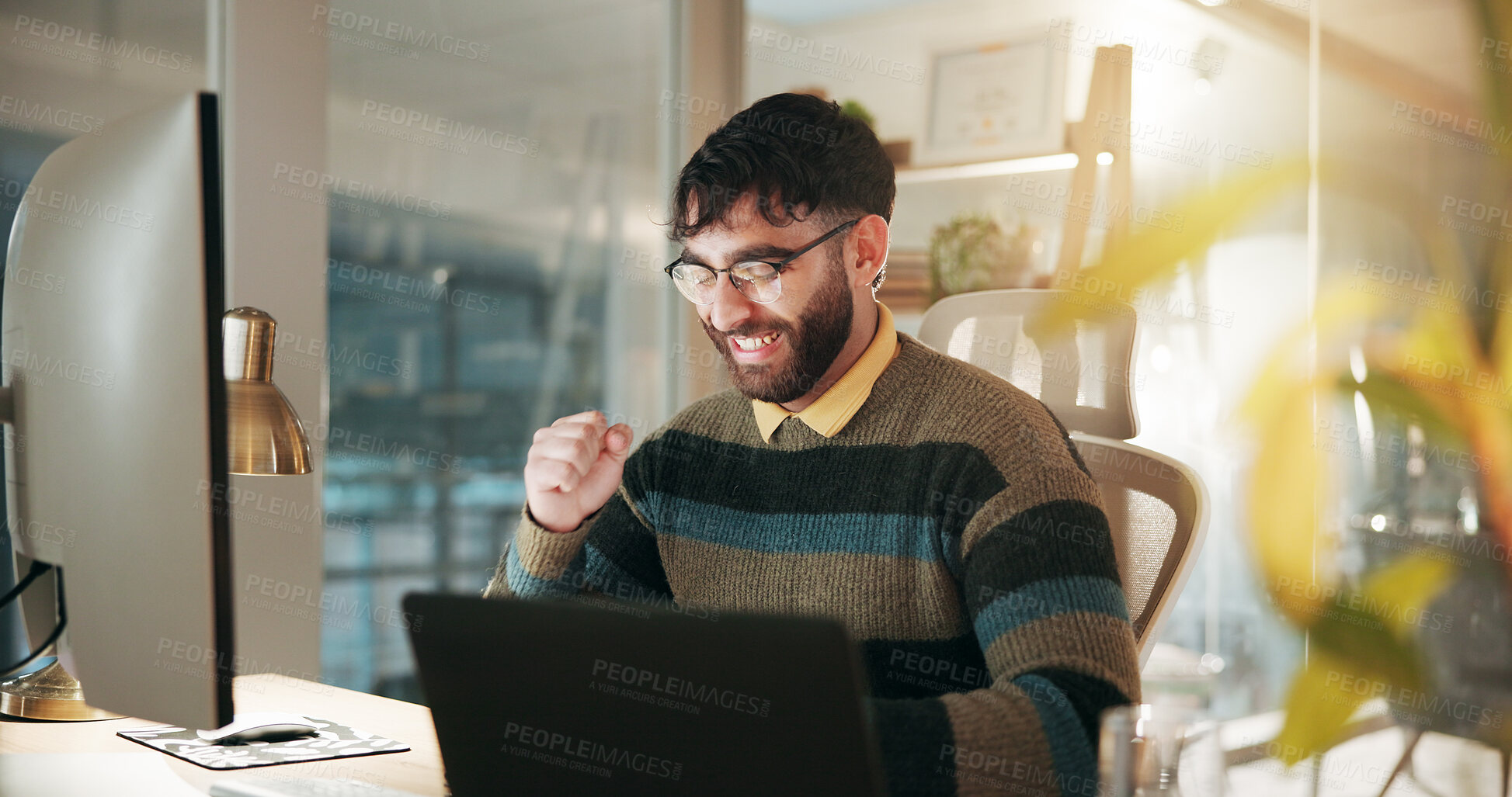Buy stock photo Business, night and man with computer, celebration and cheering with promotion, article approval and smile. Happy person, employee or writer in workplace, excited and tech with achievement or success