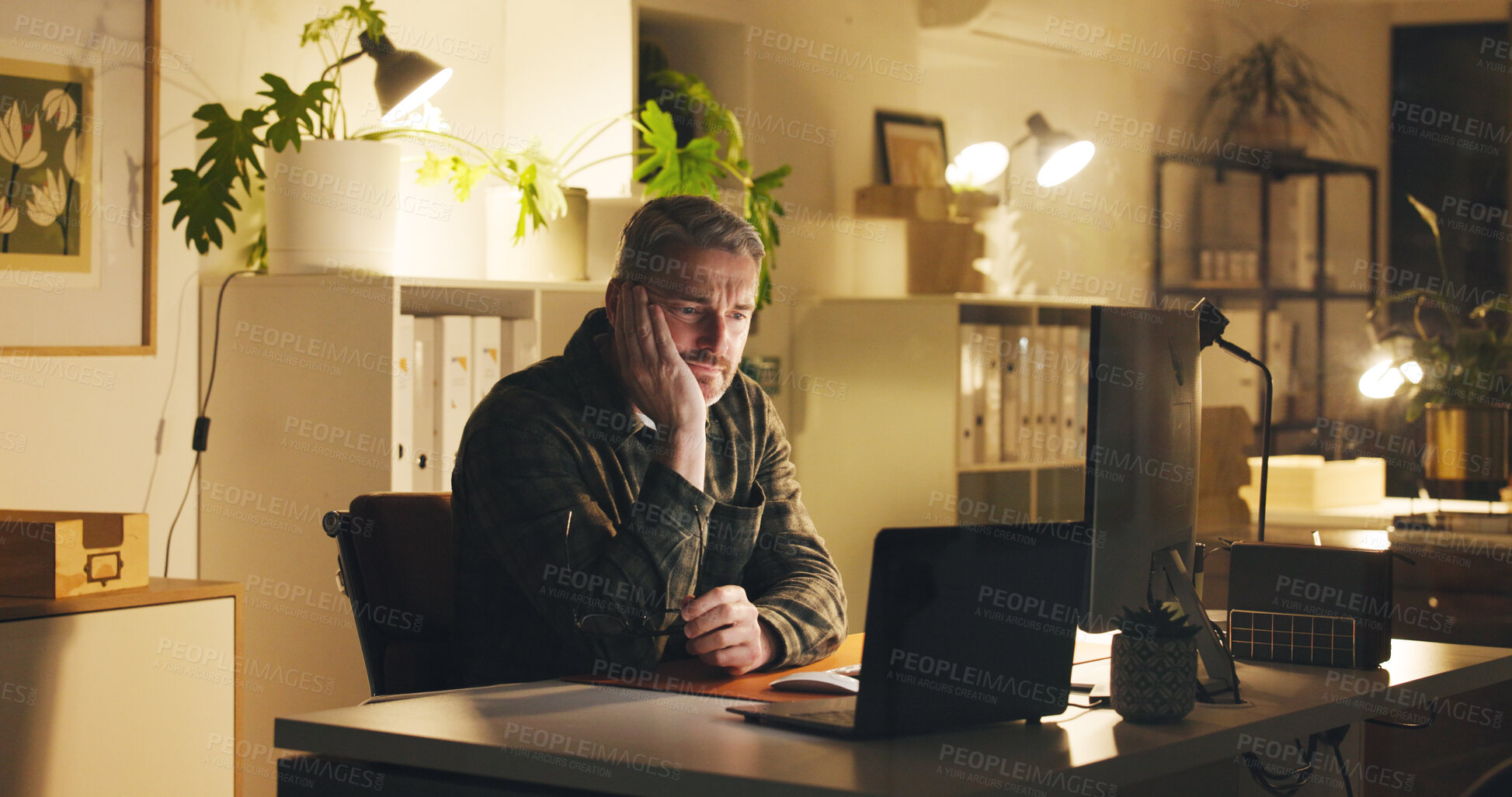 Buy stock photo Man, reading and confused at night with computer review, work article and deadline in office. Mature person, overtime and tired for research, info and thinking for draft task in publishing company