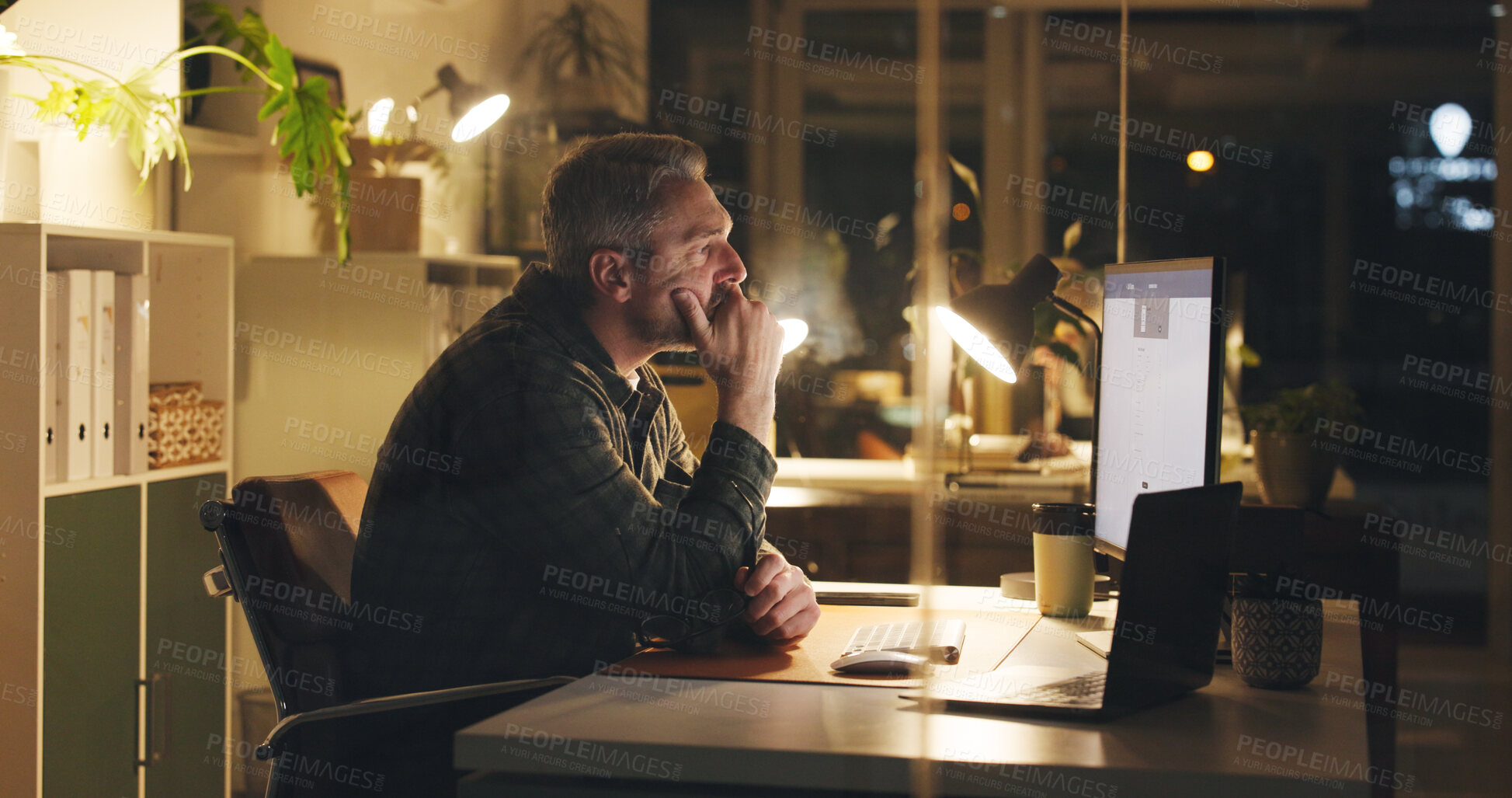 Buy stock photo Mature man, reading and computer at night in office with review, work article and deadline. Person, overtime and laptop for research, business info and thinking for draft task in publishing company