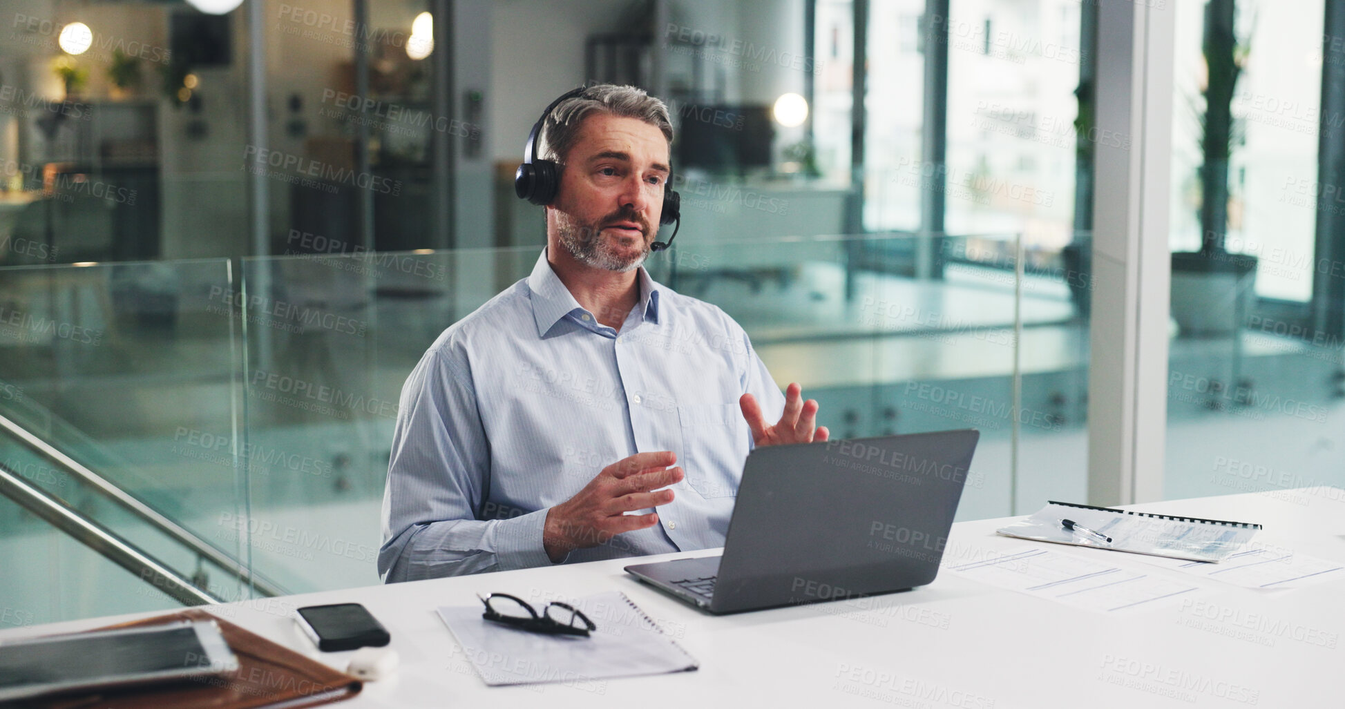 Buy stock photo Telemarketing, discussion and man with laptop in call center, talk and planning for lead generation. Agent, communication and explaining offer to contact, chat and mature person with mic for sales