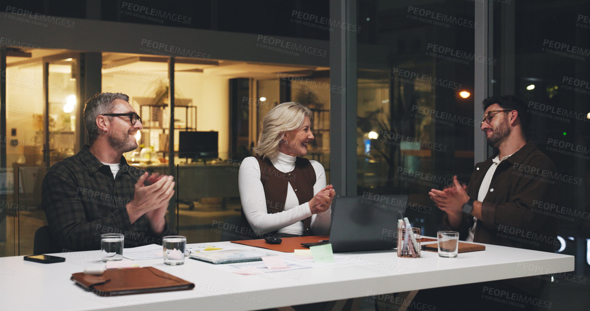 Buy stock photo Business people, applause or meeting at night, startup or happy for team achievement at media company. Group, men or woman with clapping hands, success or deadline with celebration at creative agency