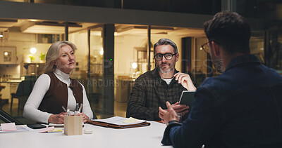 Buy stock photo Business, team and listening in meeting at night for editorial planning, story ideas or feedback. Publishing agency, people and editor with discussion for article guidance, topics review and deadline