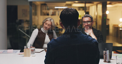 Buy stock photo Business, team and discussion in meeting at night for editorial planning, story review or ideas. Publishing agency, journalists and back of man with feedback for article headline and news development