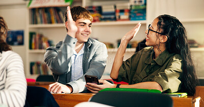 Buy stock photo Classroom, school and friends with high five for education, success or teamwork with phone. Students, teen boy and girl with celebration for goal achievement, learning and happy with scholarship