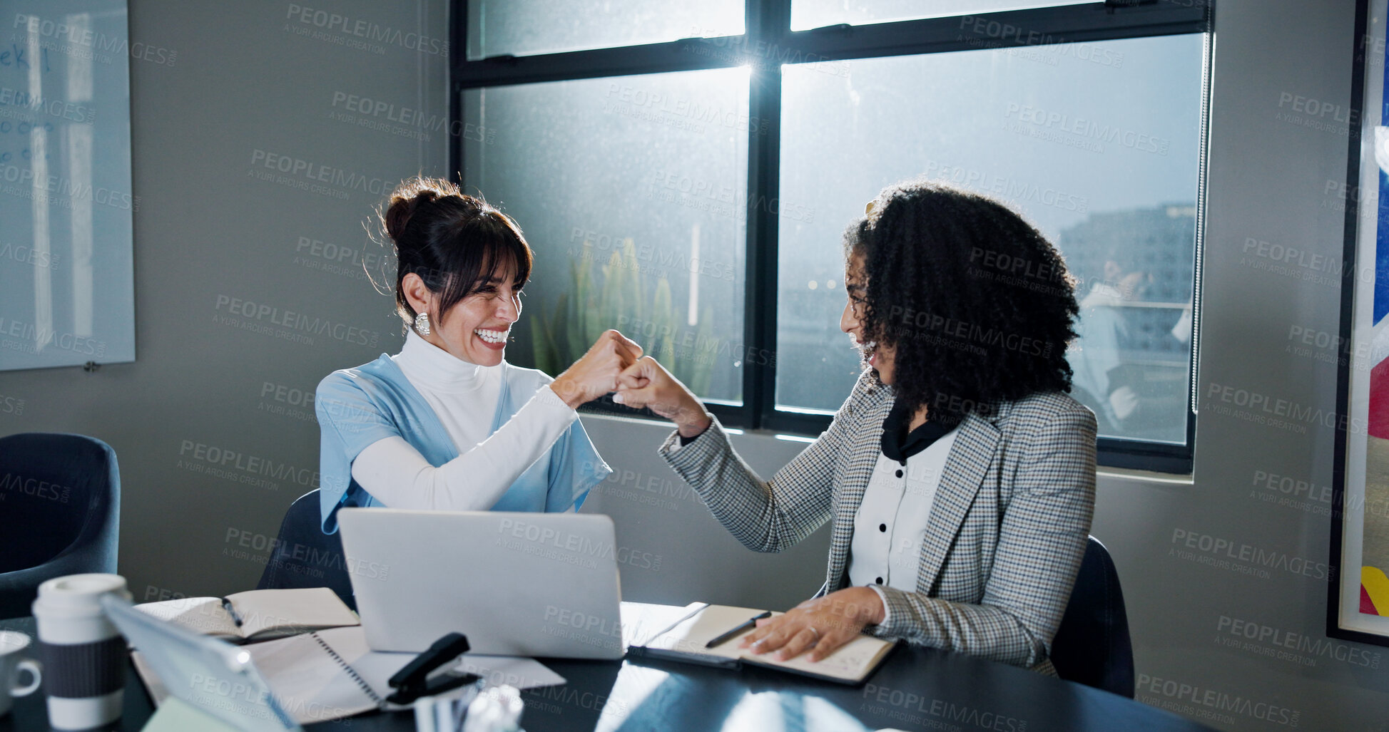 Buy stock photo Happy women, fist bump and meeting with laptop in office for winning, celebration or teamwork. Excited, female people or employees with smile or touch for good news, promotion or project success