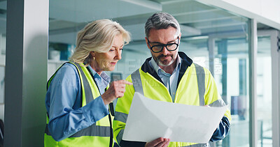 Buy stock photo Building, architect and team with blueprint, talking and people with ideas for property development. Real estate, project and mature colleagues with floor plan, engineer and discussion for renovation