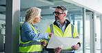 Building, architect and team with blueprint, discussion or people with idea for property development. Real estate, man and mature woman with floor plan, engineer and collaboration for renovation