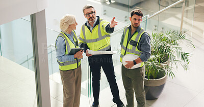 Buy stock photo Civil engineer, pointing and people with blueprint in office, talk or plan for property development. Colleagues, woman and men with document for architecture, above and discussion for renovation