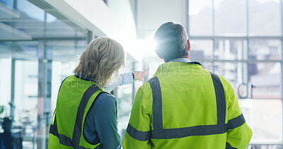 Buy stock photo Back, people and engineering with discussion at construction site, building inspection and teamwork. Architecture, civil engineer collaboration and man with woman pointing for real estate development